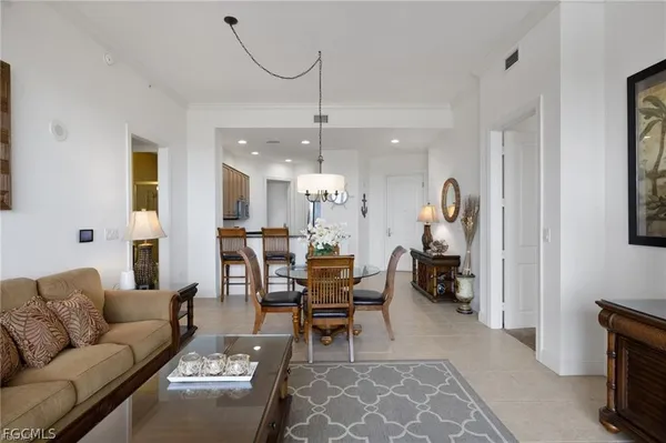 a living room with furniture a flat screen tv and a large window
