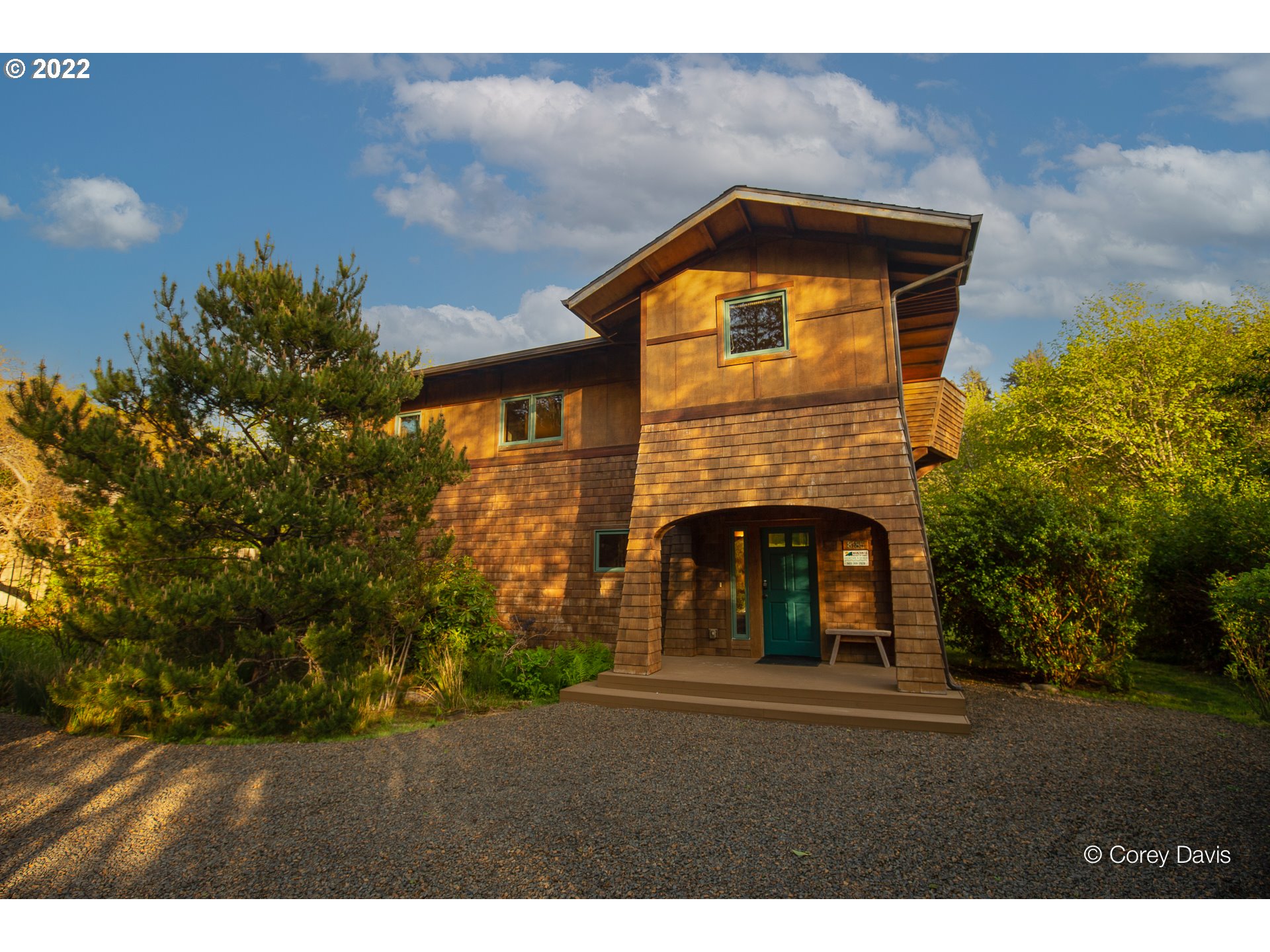 8185 Nehalem Road Manzanita, OR 97130 - Photo 1 of 31 a front view of a house with a garden