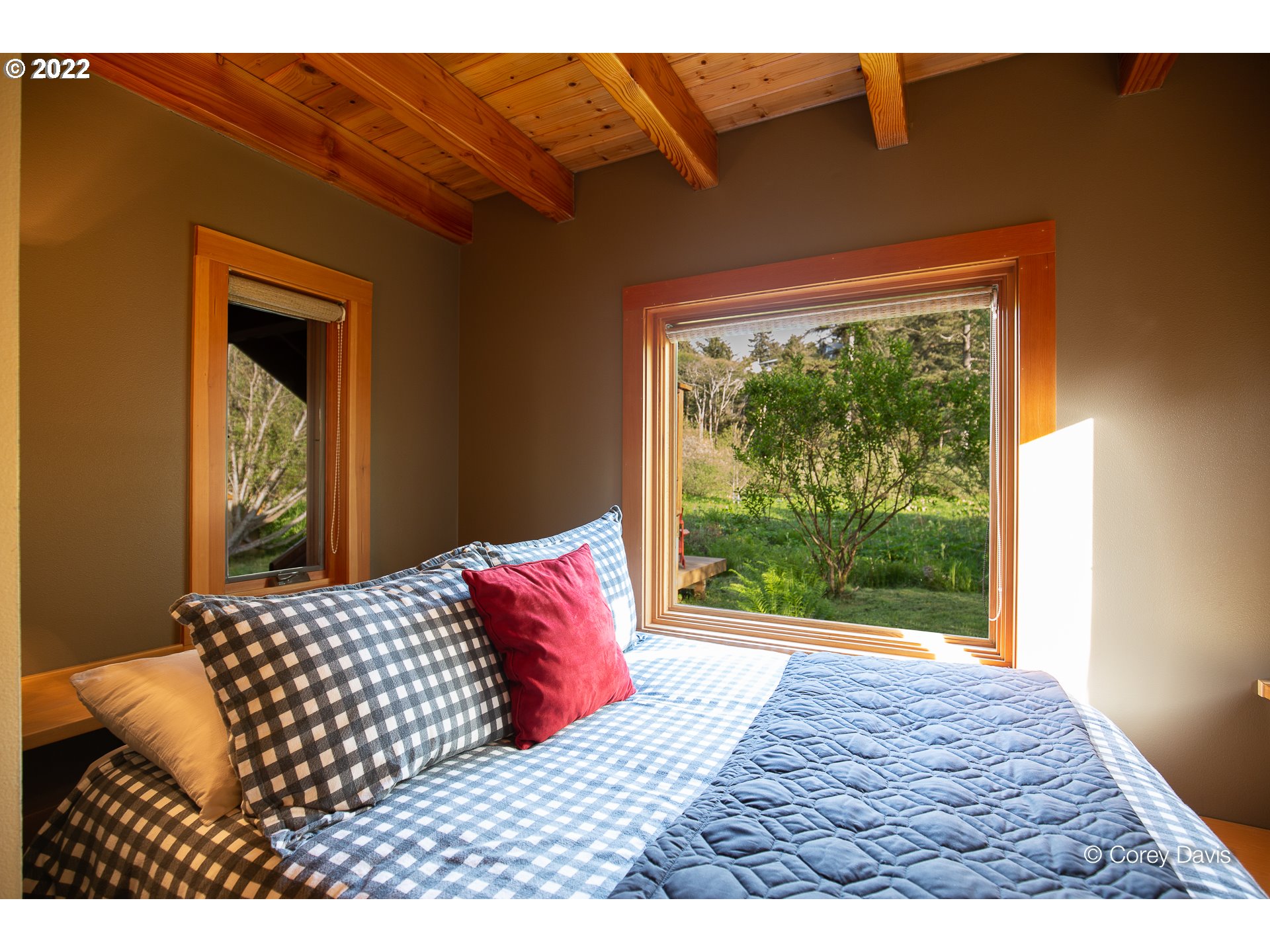 8185 Nehalem Road Manzanita, OR 97130 - Photo 25 of 31 a bedroom with a bed and a window