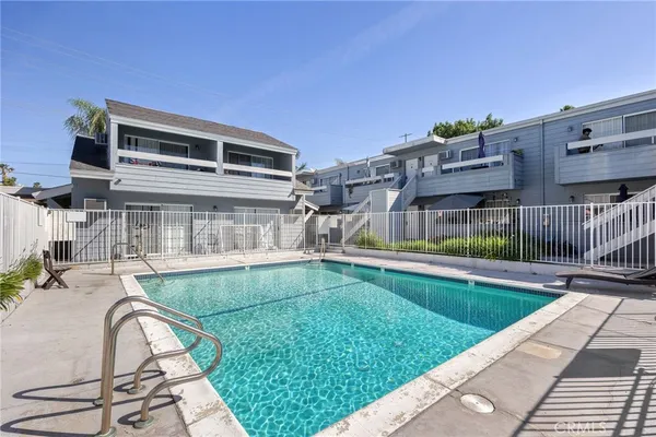 a view of a house with swimming pool and sitting area