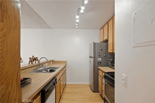 a kitchen with granite countertop a sink and a stove top oven