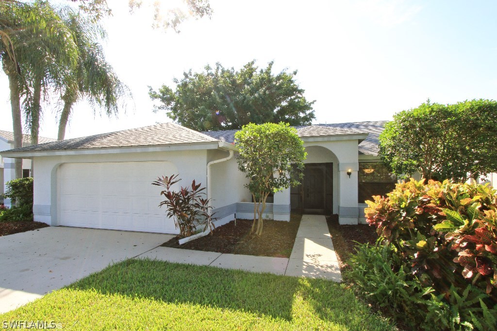 13266 Heather Ridge Loop Fort Myers, FL 33966 - Photo 1 of 12 a front view of a house with garden