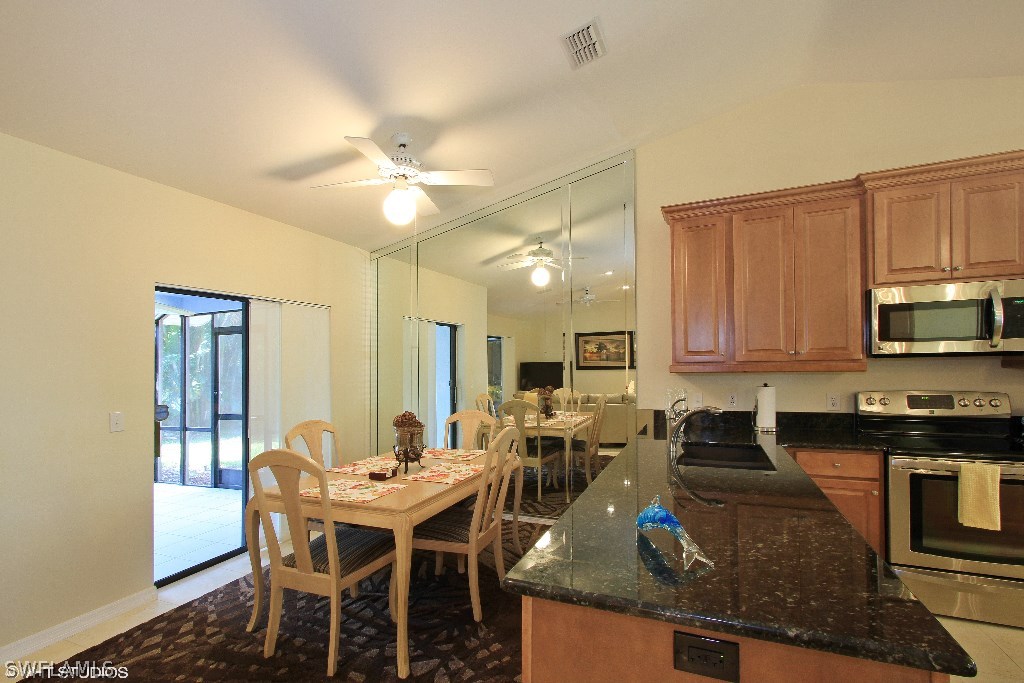 13266 Heather Ridge Loop Fort Myers, FL 33966 - Photo 3 of 12 a view of kitchen with sink dining table and chairs
