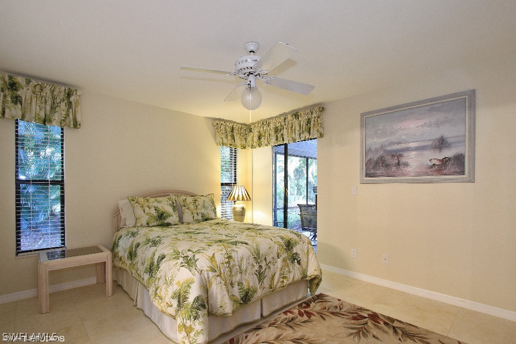 13266 Heather Ridge Loop Fort Myers, FL 33966 - Photo 6 of 12 a bedroom with a bed and a chandelier