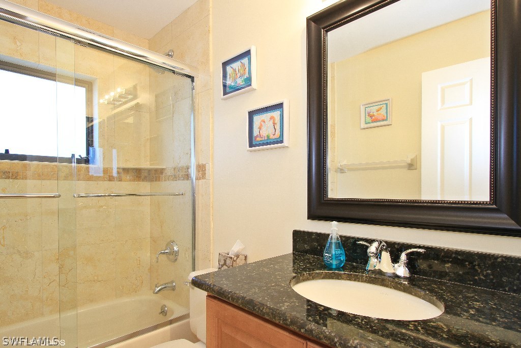 13266 Heather Ridge Loop Fort Myers, FL 33966 - Photo 7 of 12 a bathroom with a granite countertop sink and a mirror
