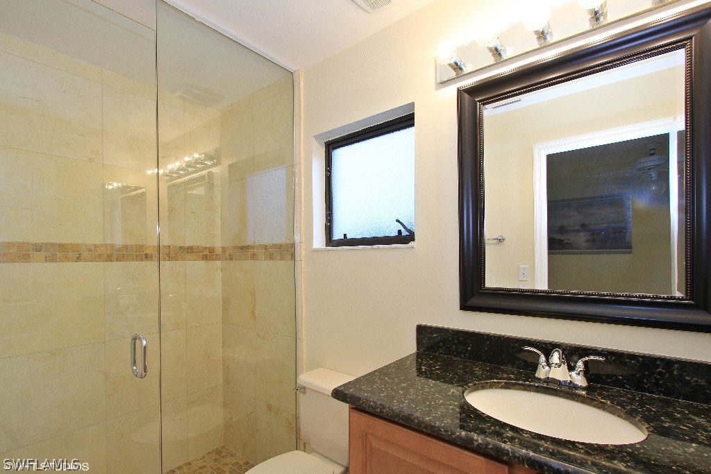 13266 Heather Ridge Loop Fort Myers, FL 33966 - Photo 9 of 12 a bathroom with a granite countertop sink a mirror and shower
