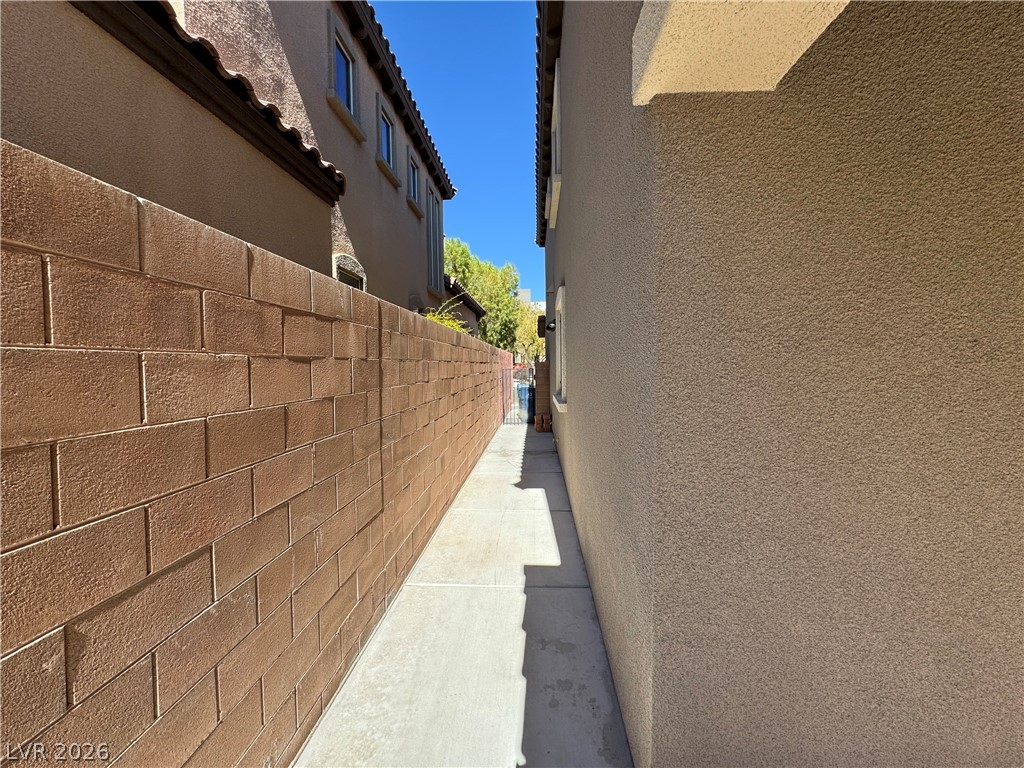 1333 Jamesbury Road Las Vegas, NV 89135 - Photo 24 of 43 A well-maintained side yard path offers convenient access between the front and back of the property.