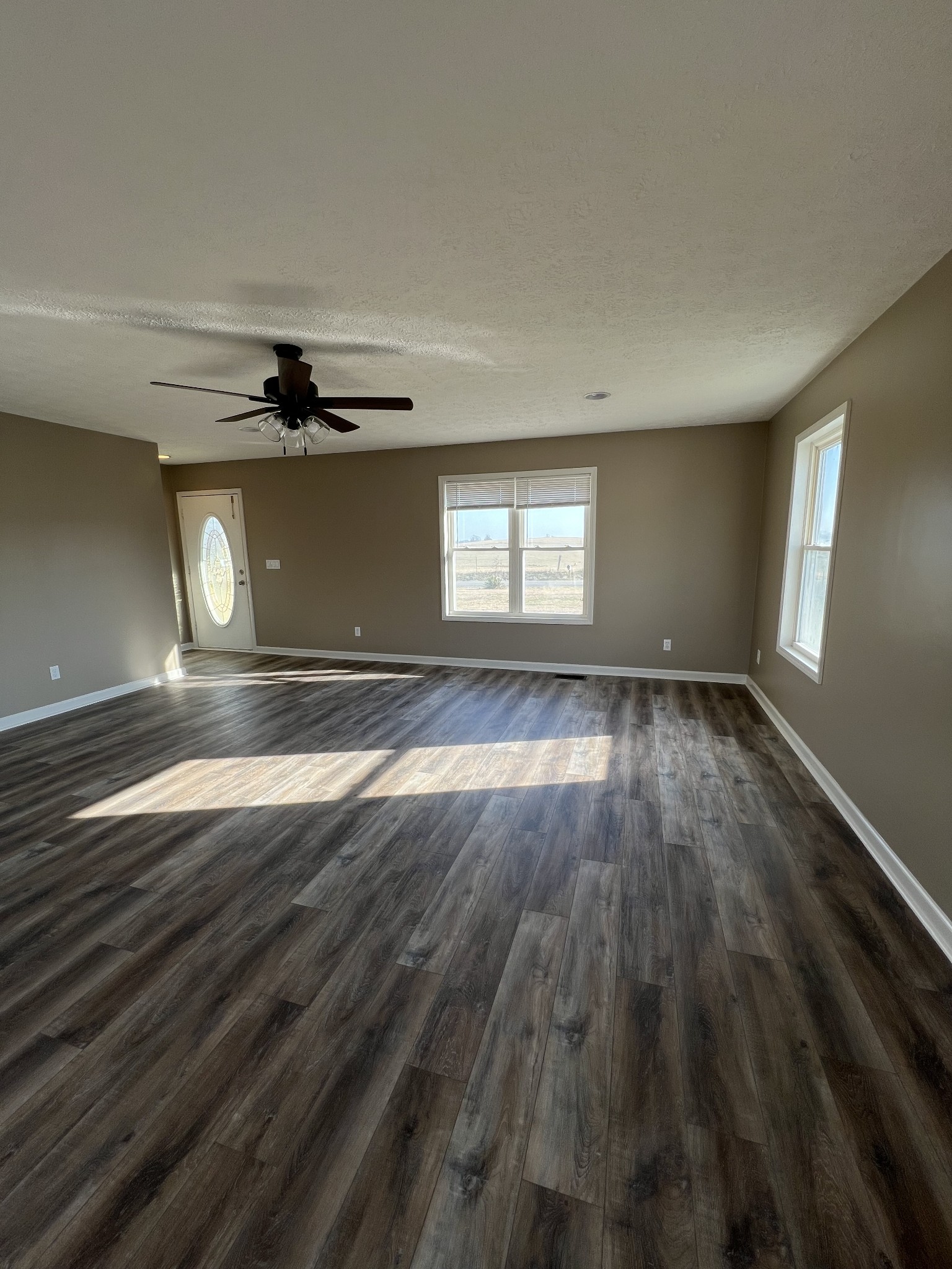 1109 W Road Red Boiling Springs, TN 37150 - Photo 2 of 14 a view of an empty room with wooden floor and a window
