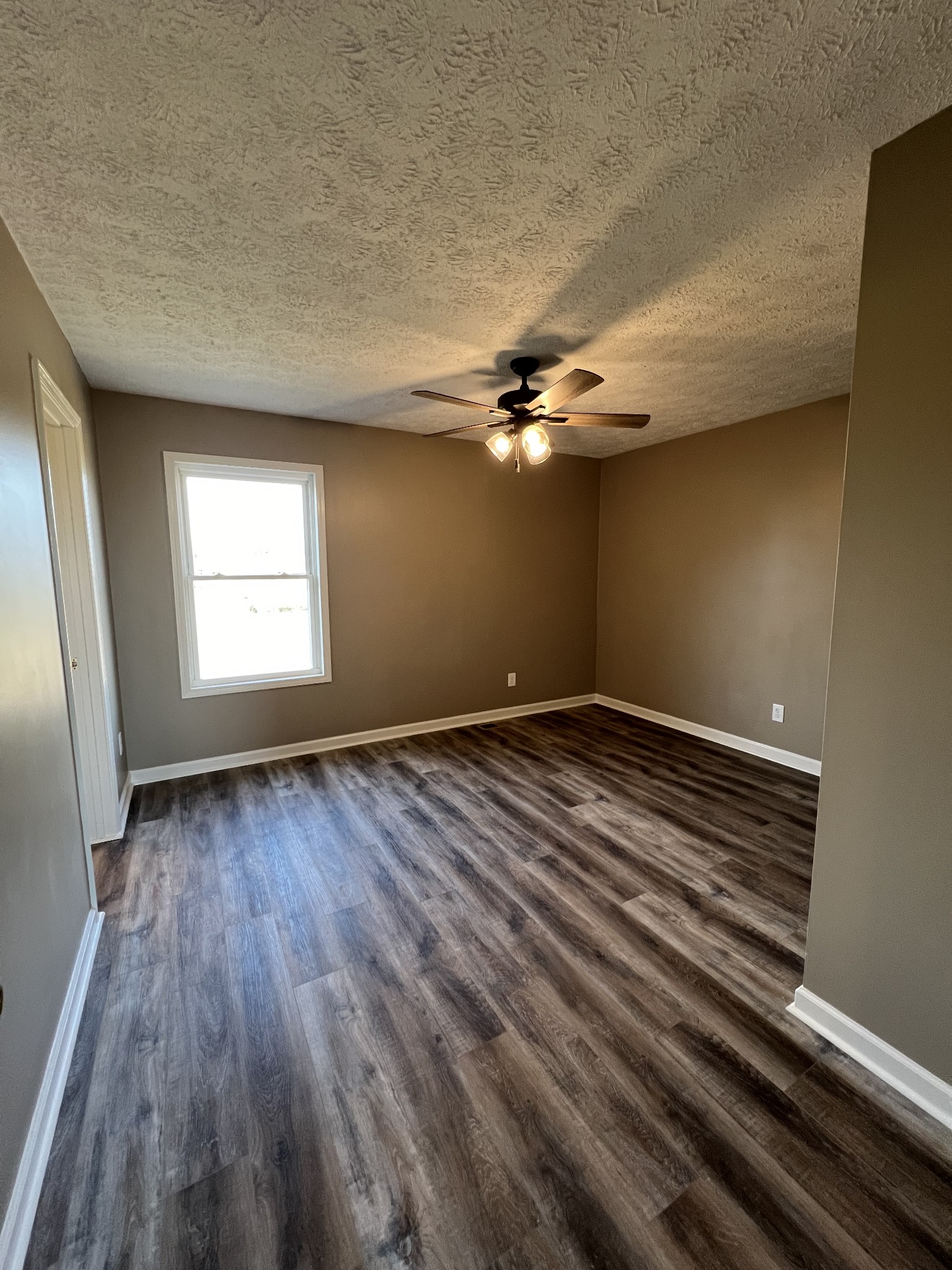 1109 W Road Red Boiling Springs, TN 37150 - Photo 5 of 14 a view of a room with wooden floor and fan