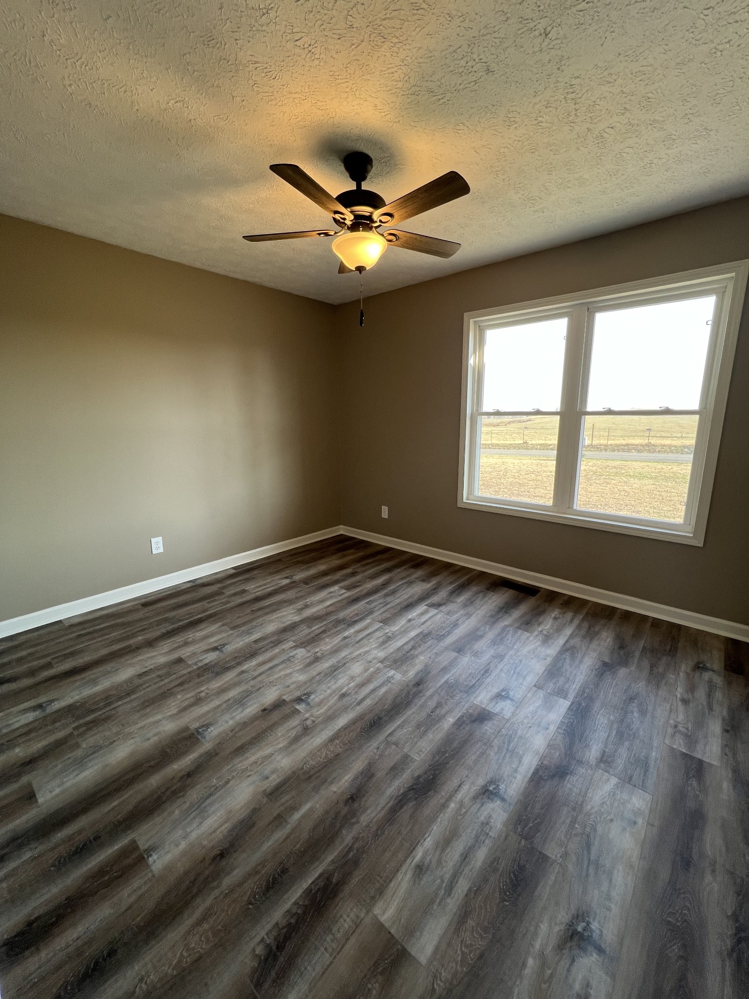 1109 W Road Red Boiling Springs, TN 37150 - Photo 7 of 14 a view of an empty room with window and wooden floor