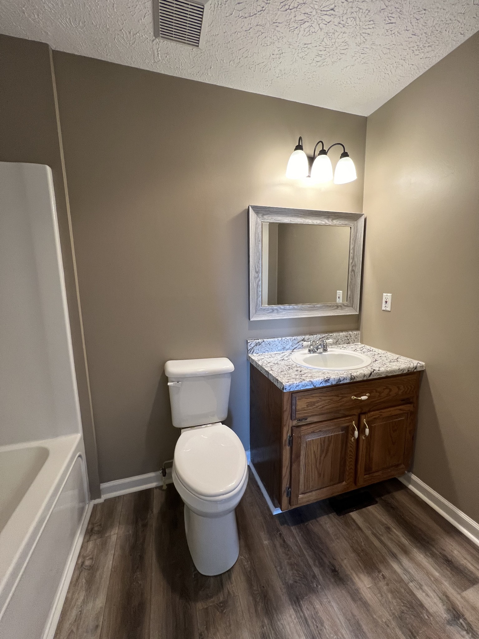 1109 W Road Red Boiling Springs, TN 37150 - Photo 8 of 14 a bathroom with a granite countertop toilet sink and mirror