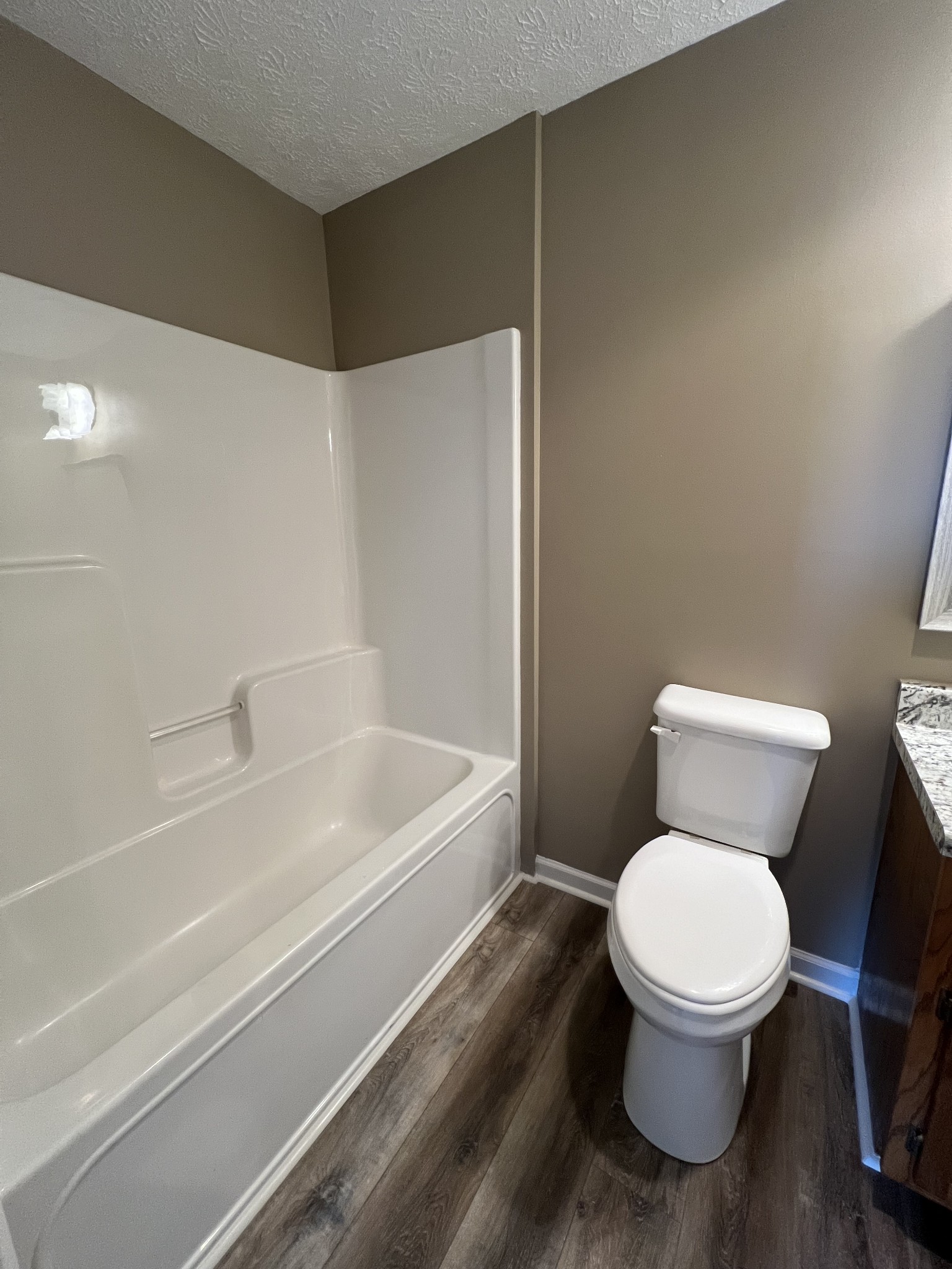1109 W Road Red Boiling Springs, TN 37150 - Photo 9 of 14 a white toilet sitting next to a bath tub
