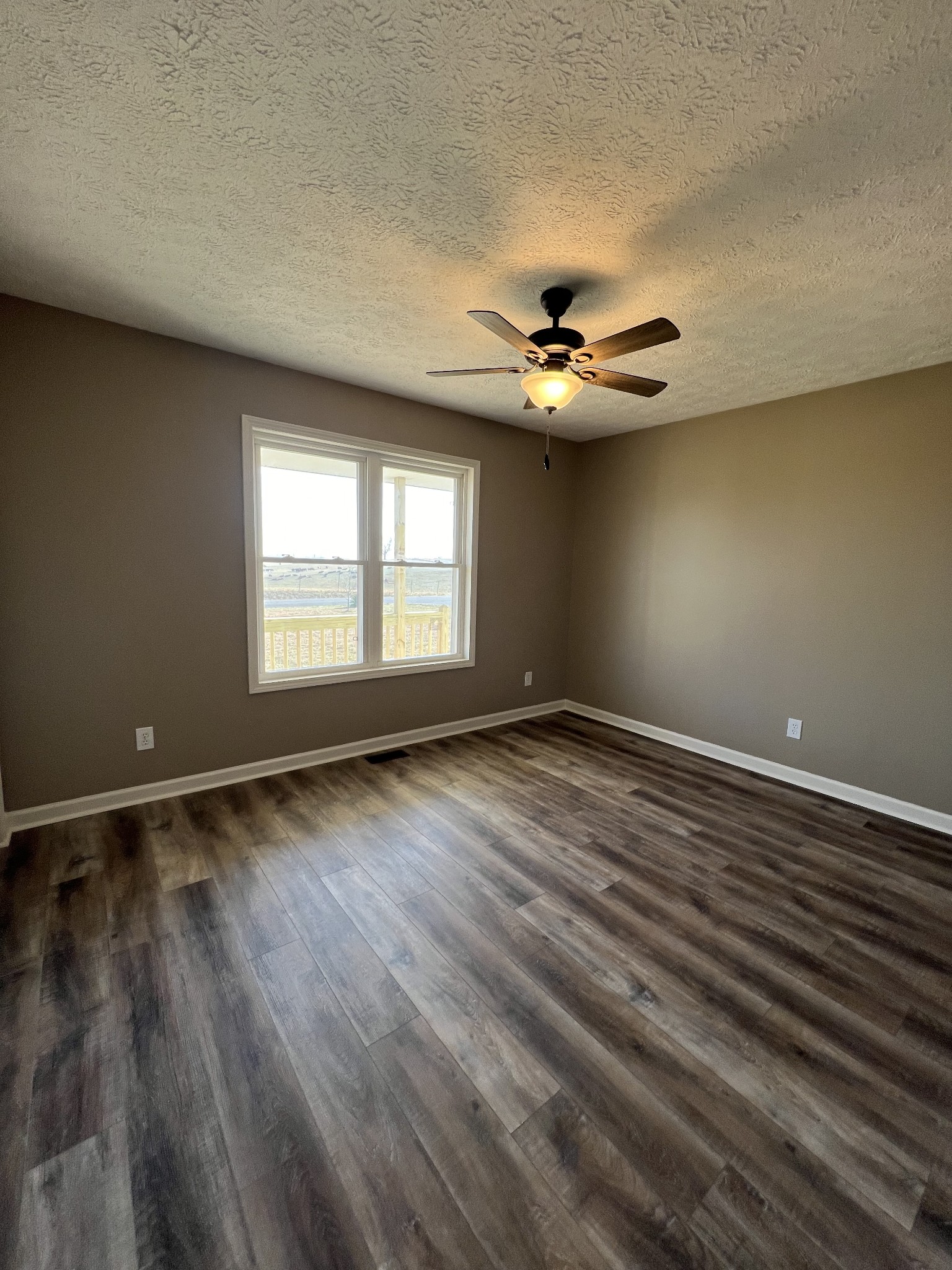 1109 W Road Red Boiling Springs, TN 37150 - Photo 10 of 14 wooden floor in an empty room with a window