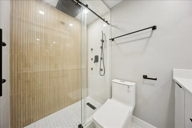 a white toilet sitting next to a bathroom sink