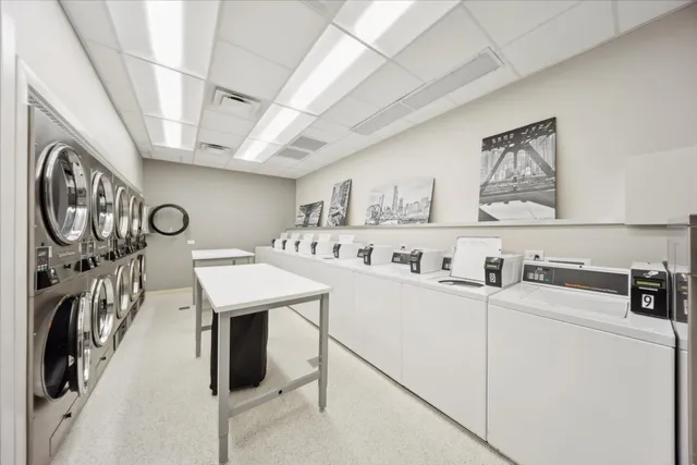 a utility room with dryer washer and a view of living room