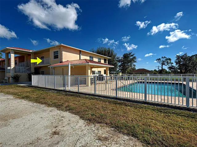 a view of a house with wooden fence
