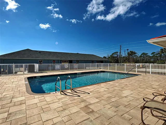 a porch with a table and chairs and potted plants