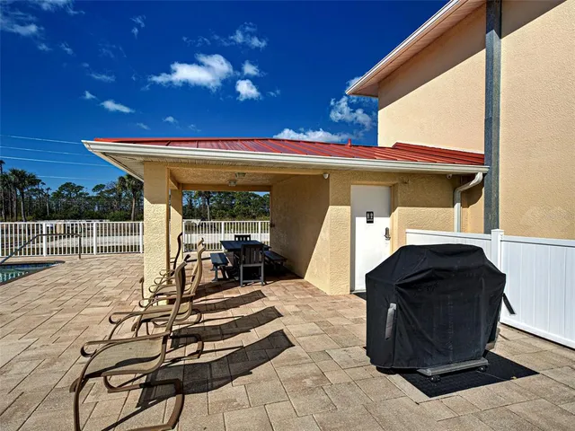 a view of a house with backyard porch and sitting area