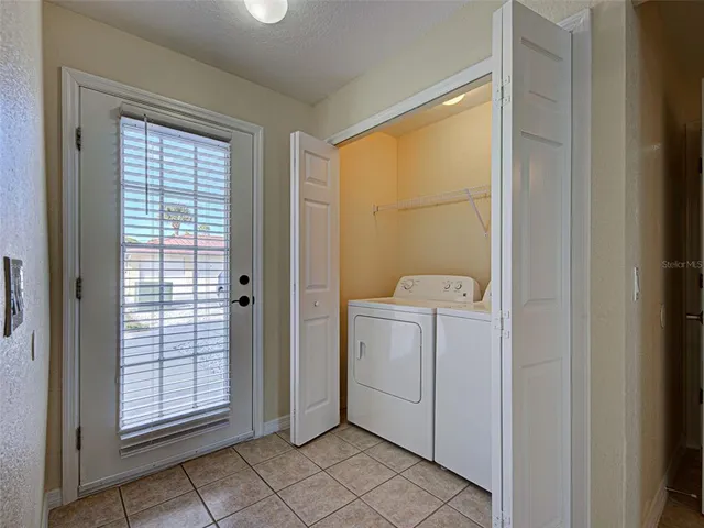 a kitchen with granite countertop a refrigerator and a stove top oven