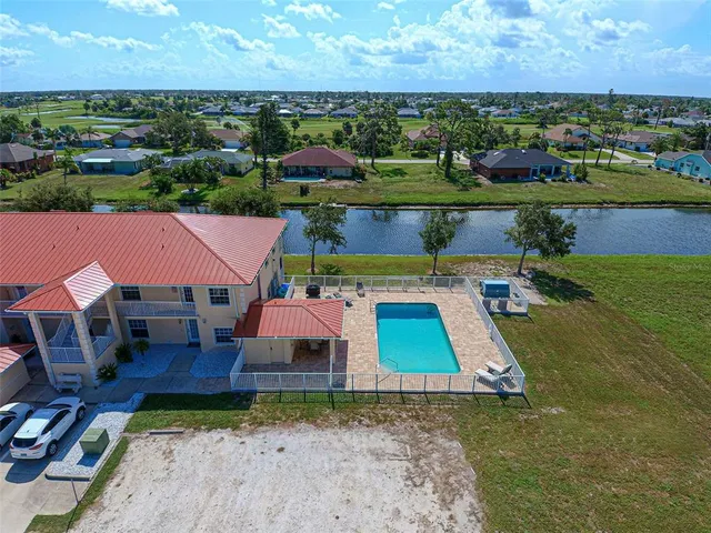 an aerial view of a house with pool lake view and mountain view