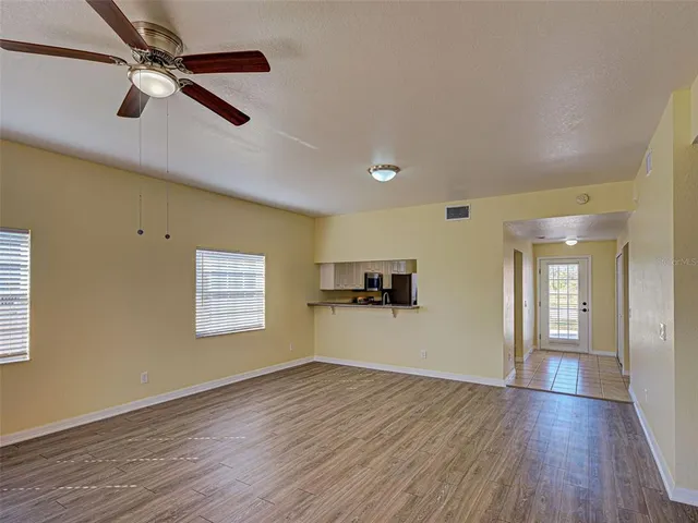 an empty room with wooden floor and a window