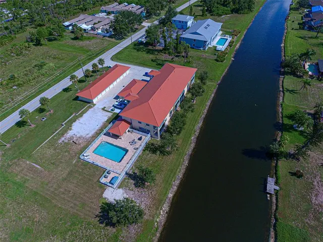 an aerial view of a house with a yard basket ball court and outdoor seating