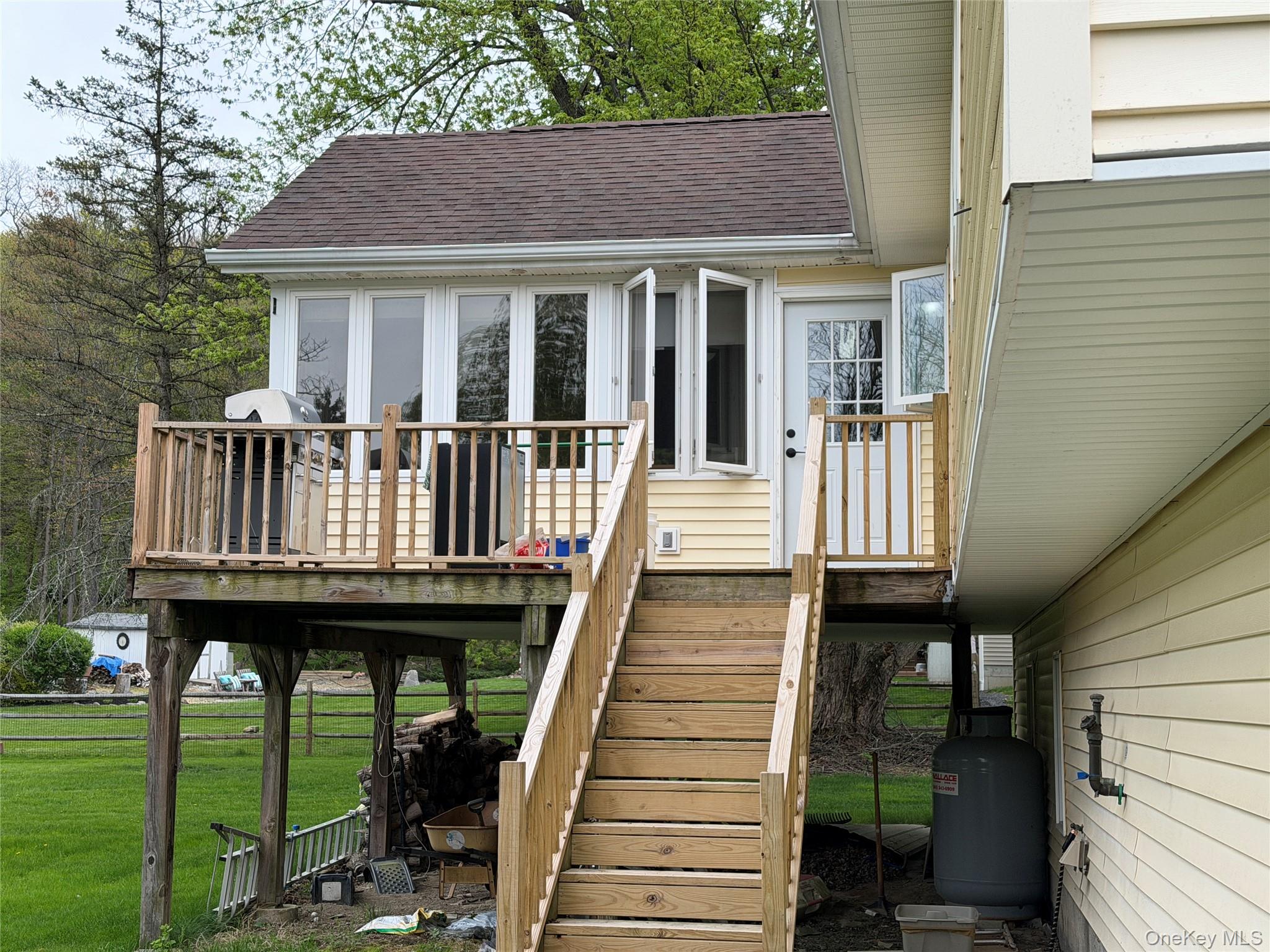 94 Booth Road Chester, NY 10918 - Photo 17 of 21 Elevated wood deck with natural wood railings, stairs to yard