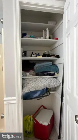 a shelf with cup and plates