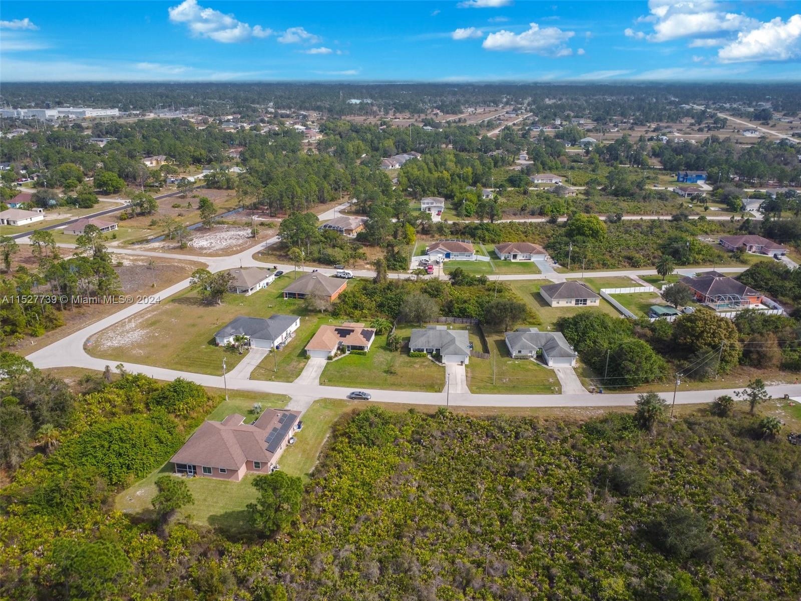 752 Breamer Avenue South Lehigh Acres, FL 33974 - Photo 6 of 10 an aerial view of residential houses with outdoor space and trees