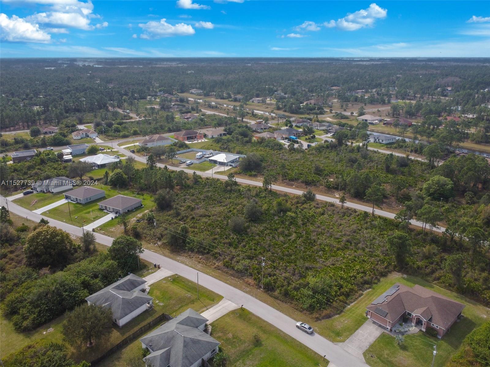 752 Breamer Avenue South Lehigh Acres, FL 33974 - Photo 8 of 10 an aerial view of residential houses with outdoor space