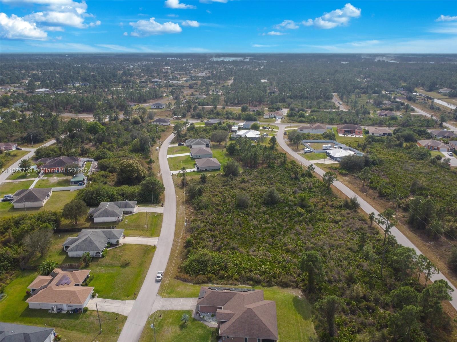 752 Breamer Avenue South Lehigh Acres, FL 33974 - Photo 10 of 10 an aerial view of residential houses with outdoor space
