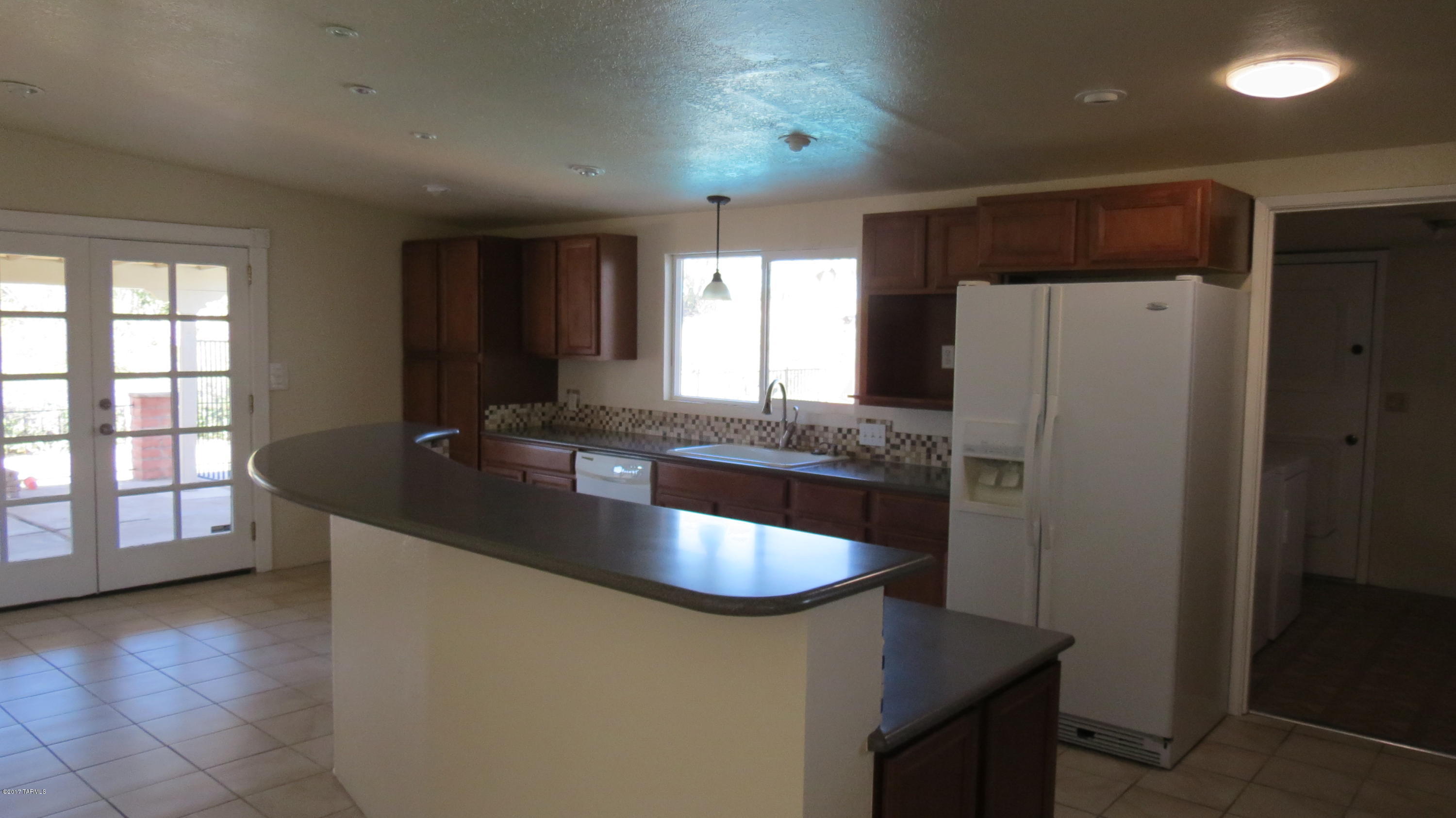 6601 North Mona Lisa Road Tucson, AZ 85741 - Photo 3 of 23 a kitchen with stainless steel appliances granite countertop a sink a stove and a refrigerator