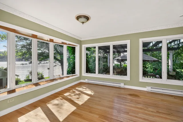 a view of a livingroom with wooden floor window and entryway