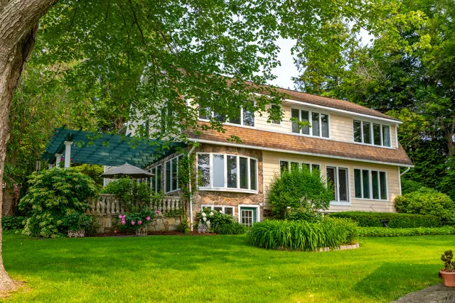 a front view of a house with a garden