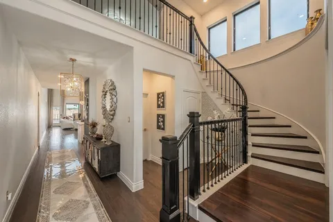 a view of entryway and hall with wooden floor