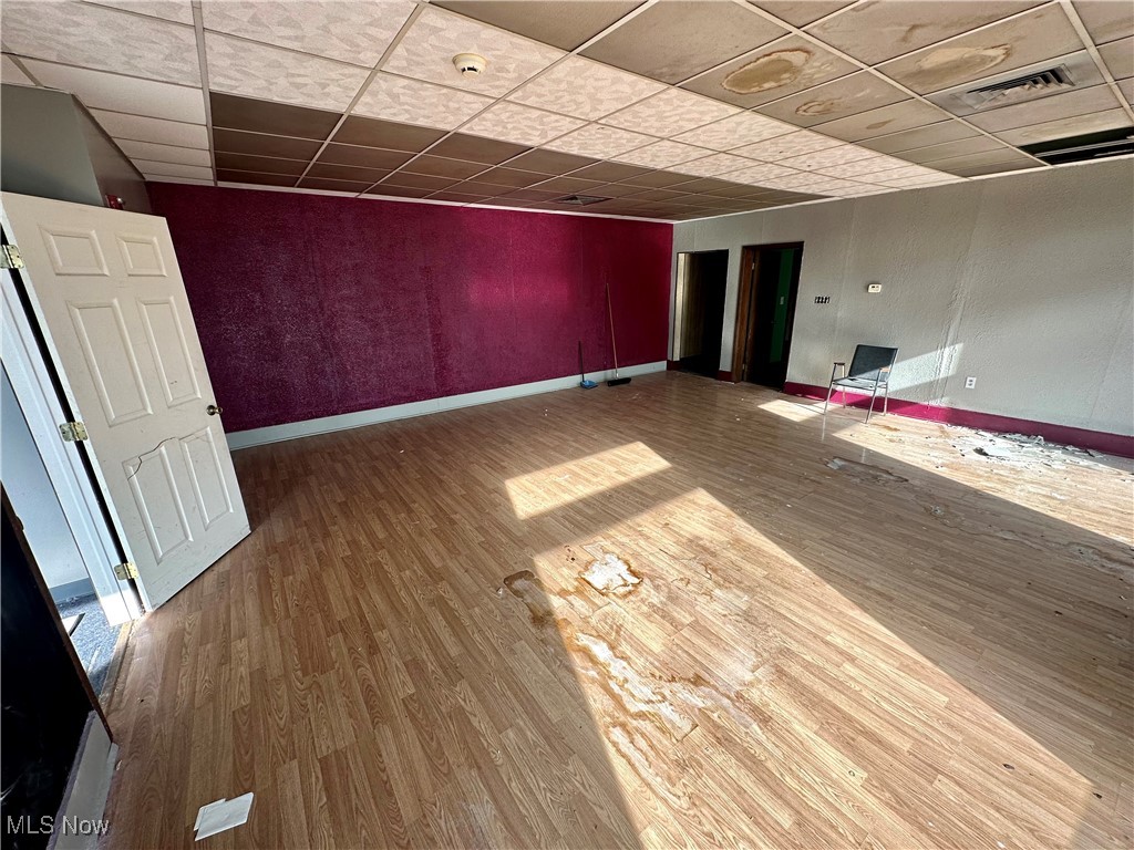800 Main Street Follansbee, WV 26037 - Photo 13 of 20 Empty room with a paneled ceiling and wood-type flooring