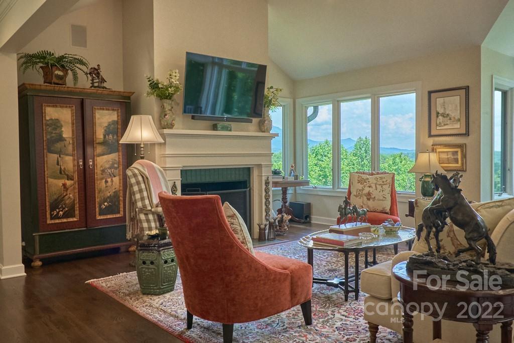400 Ridgetop Road Tryon, NC 28782 - Photo 12 of 39 a living room with furniture a fireplace and a floor to ceiling window