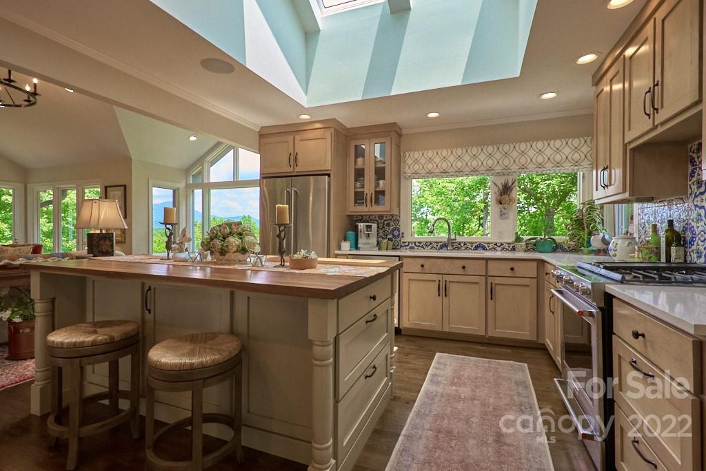400 Ridgetop Road Tryon, NC 28782 - Photo 20 of 39 a kitchen with a sink and chairs