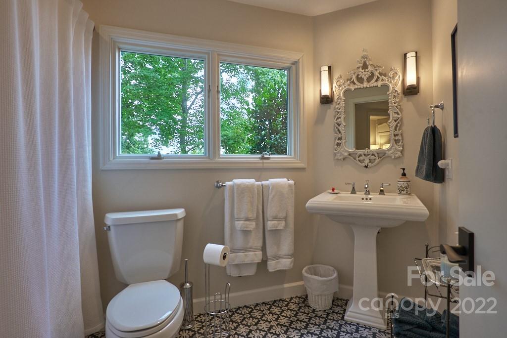 400 Ridgetop Road Tryon, NC 28782 - Photo 38 of 39 a bathroom with a toilet sink and mirror