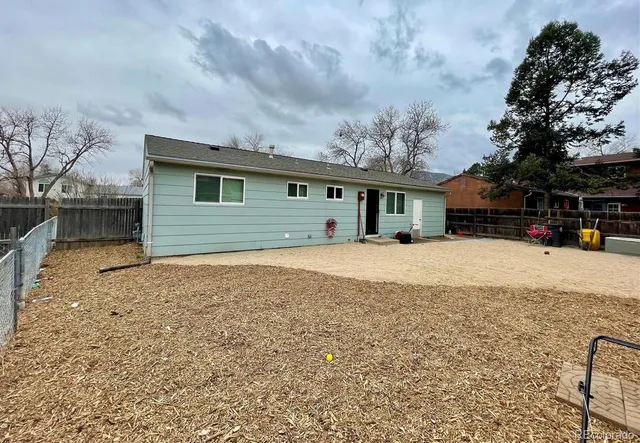 a front view of house with yard and car parked