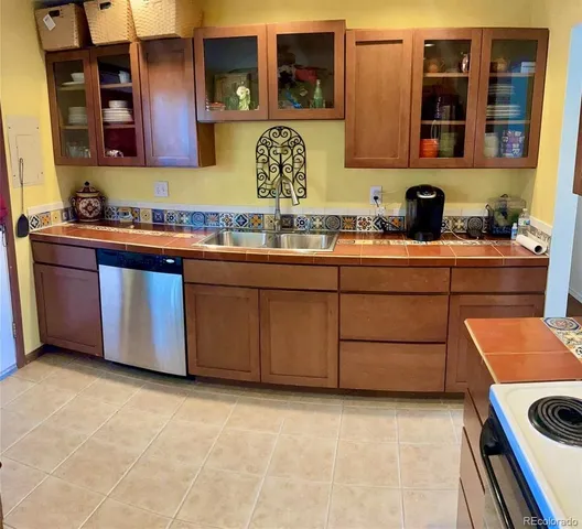 a kitchen with stainless steel appliances granite countertop a stove and a sink