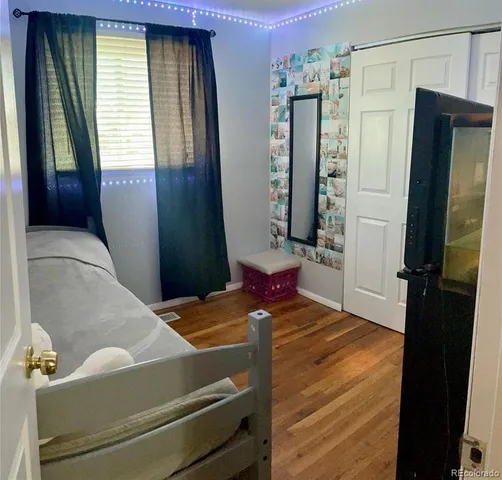 a bedroom with a bed and a mirror