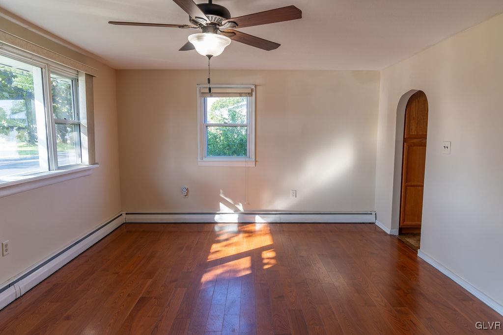 574 Bangor Road Easton, PA 18040 - Photo 5 of 39 an empty room with wooden floor chandelier fan and windows