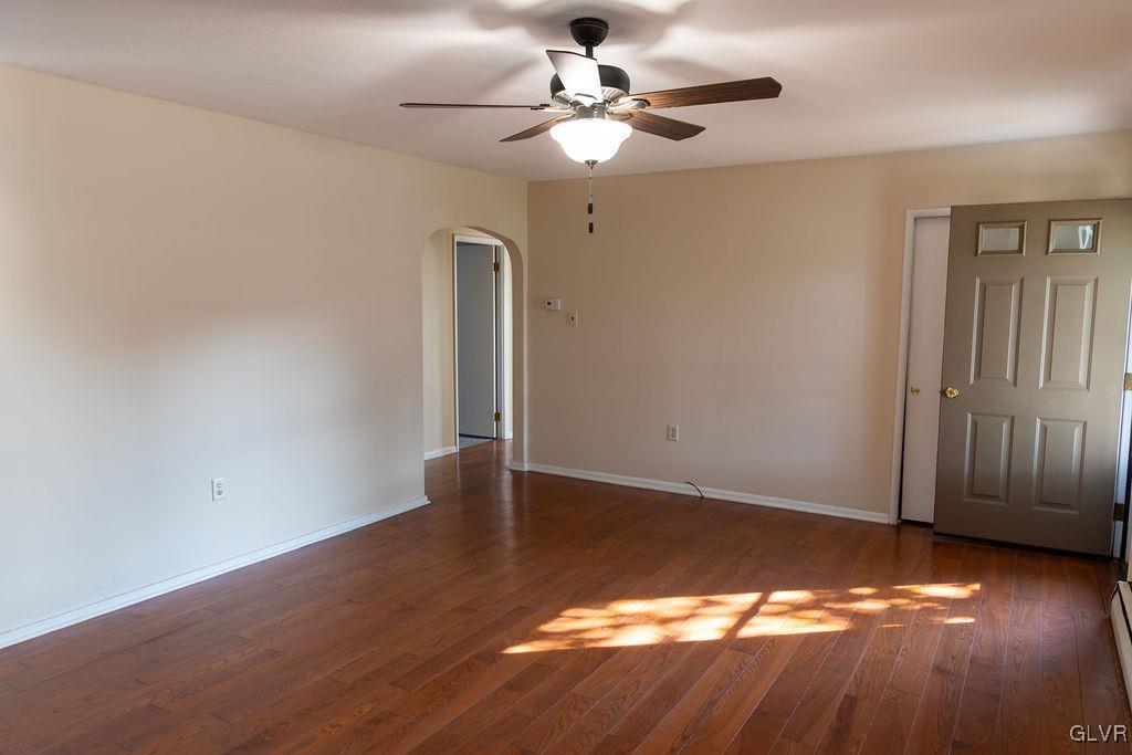 574 Bangor Road Easton, PA 18040 - Photo 6 of 39 an empty room with wooden floor chandelier fan and windows