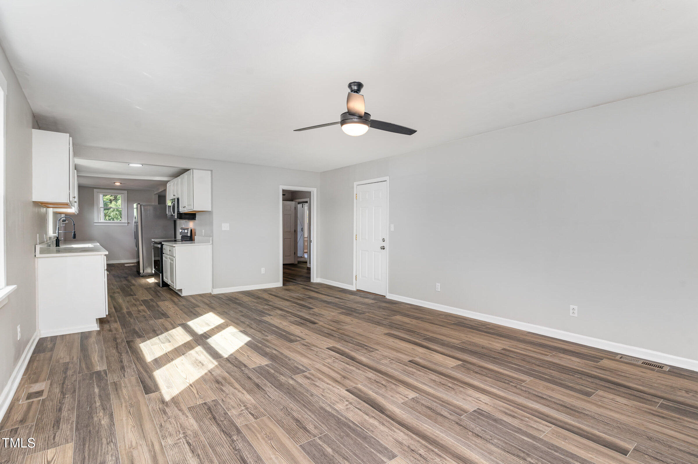 1323 Camden Road Fayetteville, NC 28306 - Photo 12 of 30 a view of a living room with hardwood floor and a ceiling fan