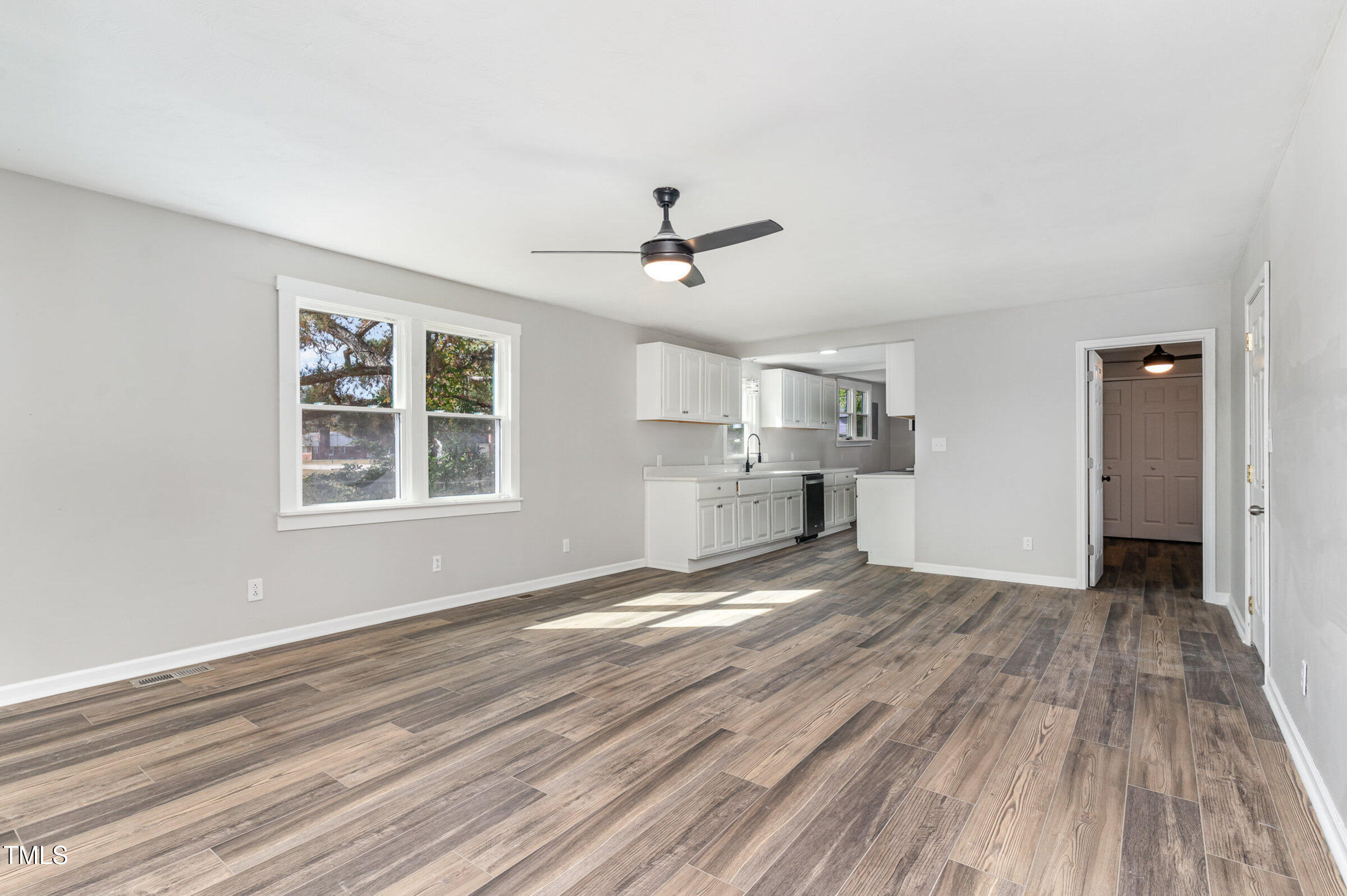 1323 Camden Road Fayetteville, NC 28306 - Photo 13 of 30 wooden floor in an empty room with a window