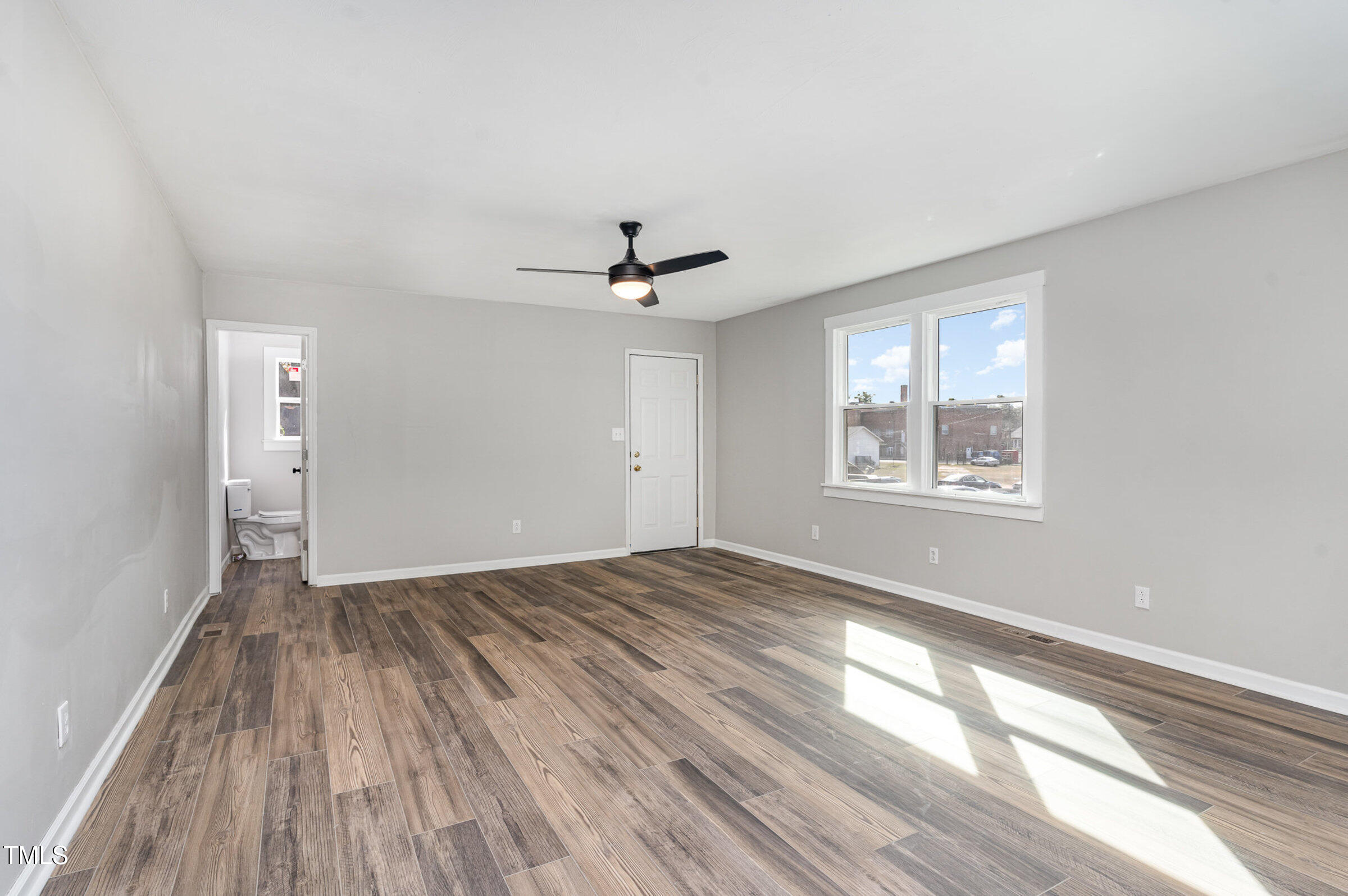 1323 Camden Road Fayetteville, NC 28306 - Photo 14 of 30 a view of empty room with wooden floor and fan