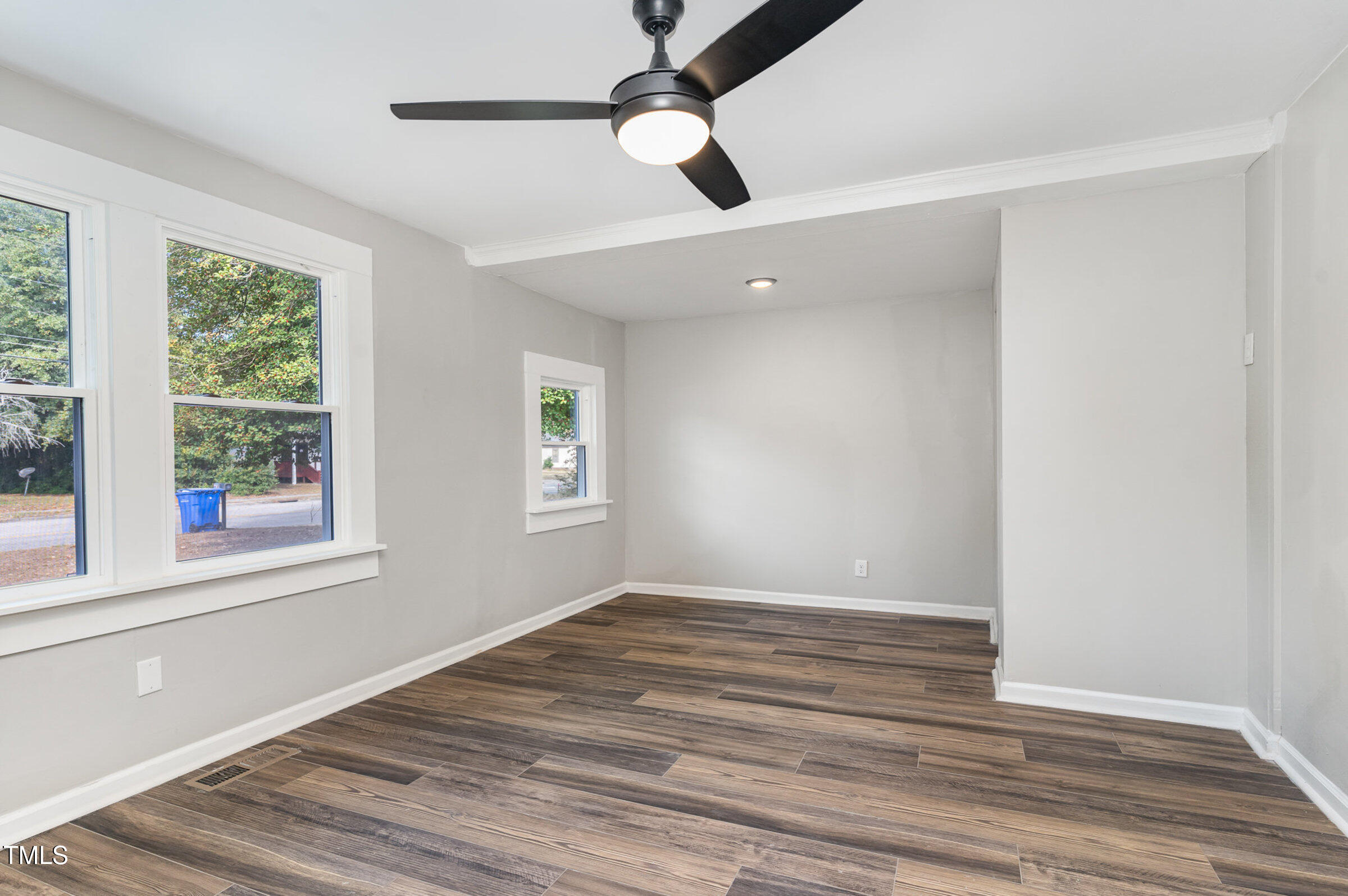 1323 Camden Road Fayetteville, NC 28306 - Photo 15 of 30 a view of an empty room with wooden floor and a window
