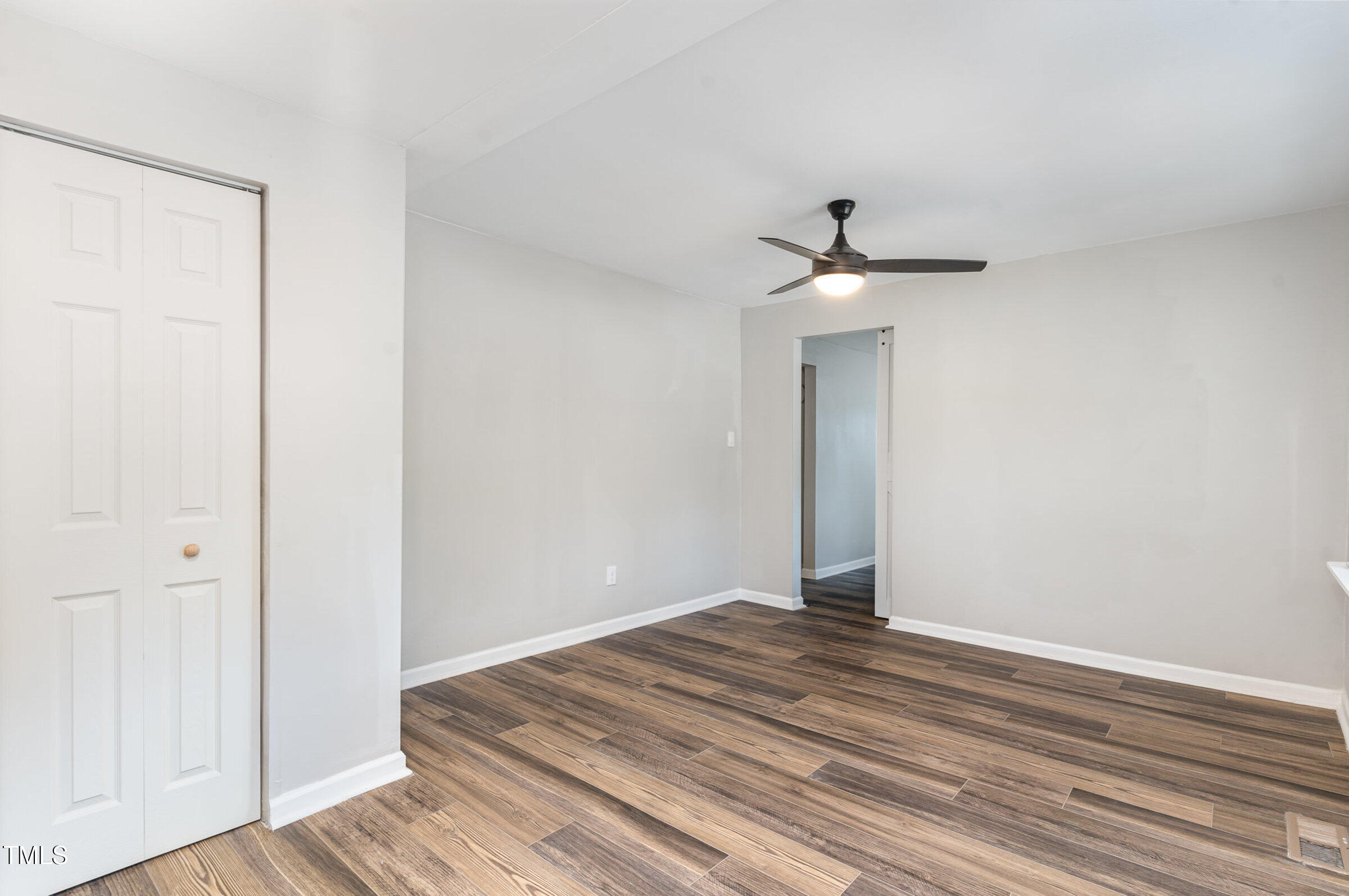 1323 Camden Road Fayetteville, NC 28306 - Photo 16 of 30 a view of a room with wooden floor and a ceiling fan