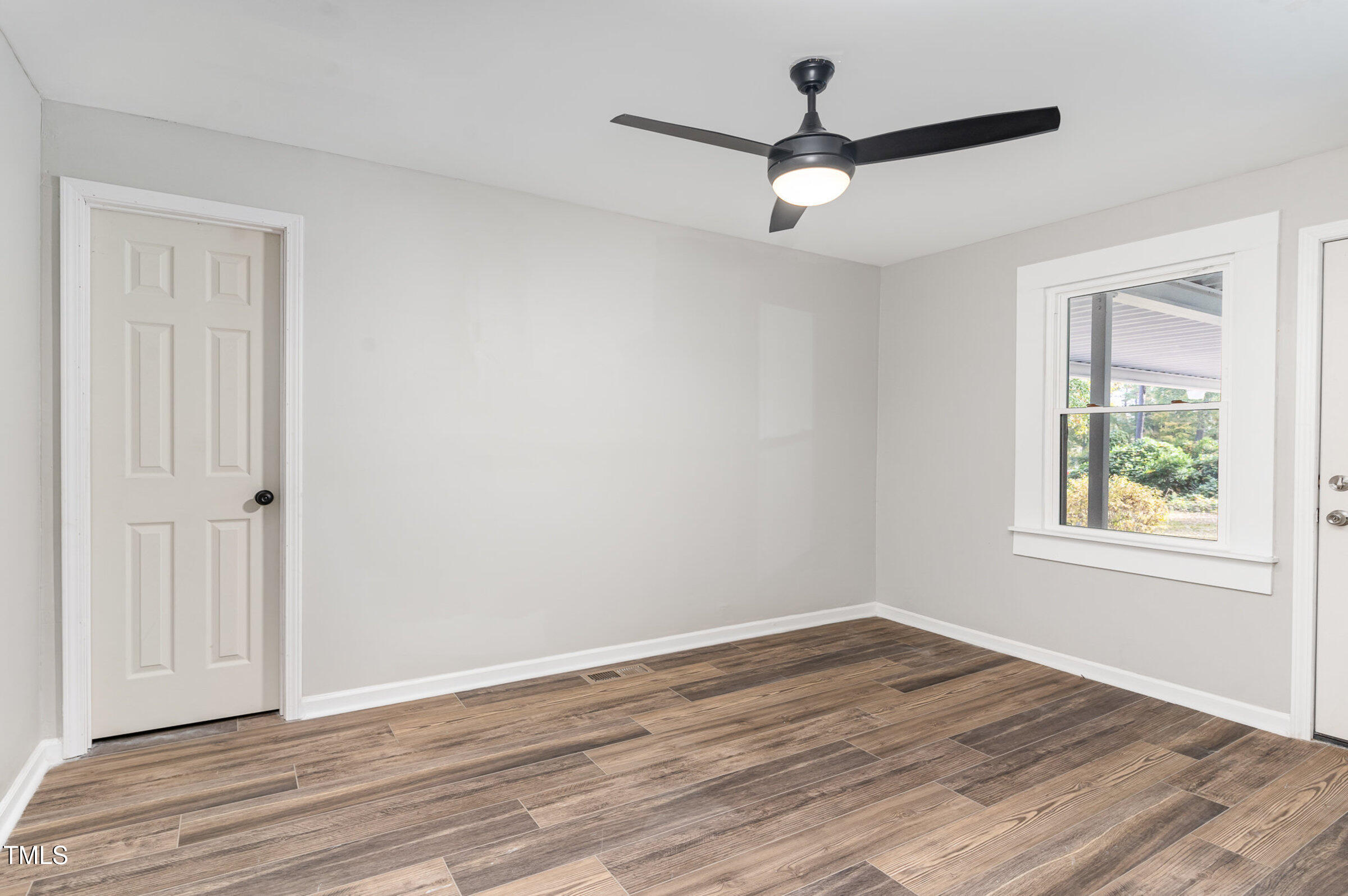 1323 Camden Road Fayetteville, NC 28306 - Photo 17 of 30 a view of an empty room with wooden floor and a window